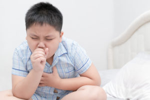 Sick boy coughing